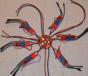 The 250a power distribution board is attached to the bottom of the center top plate.  Also seen are the two battery leads as well as two power leads for the DJI Zenmuse and PDU.  The Vulcan speed control programmer is attached and ready to calibrate all six Maytech speed controls.  