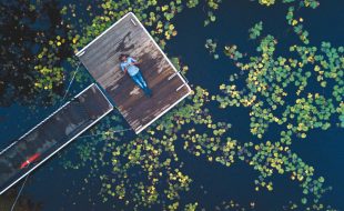 Central Coast, New South Wales, Australia
f2.2—1/13s—ISO 200
My mission here was to capture the beautiful contrasting colors and textures of the lily pads, water, and wharf. Hence, I decided to elevate the drone to about 45 to 60 feet as it allowed me encapsulate every part of the scene I wanted to. It also helped me crop out other potential distractions, such as grassy banks, that could have crept into the scene. Cropping out the grassy banks also added a dark sense of mystery. I also tilted the frame by positioning the wharf at 45 degrees just to break the overall horizontality of the composition.